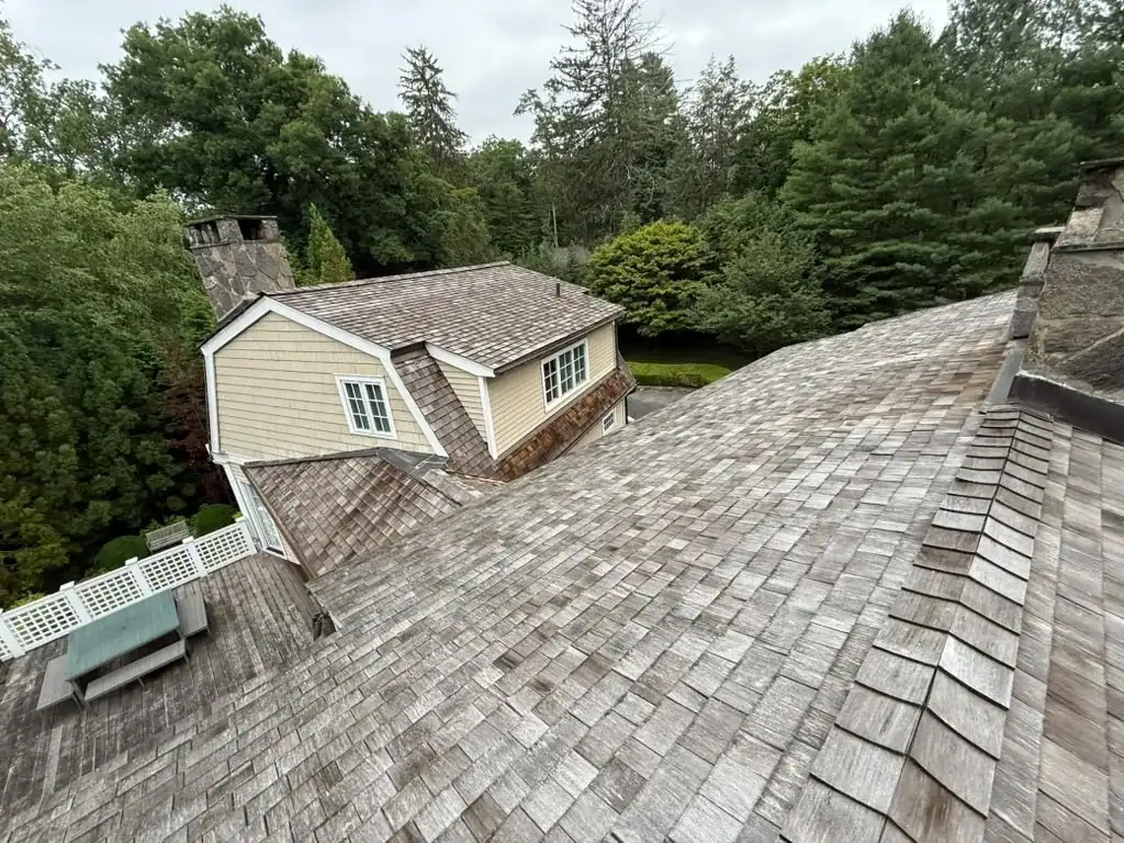 Weathered gray cedar shakes before cleaning in Cos Cob