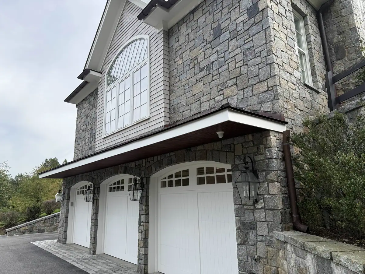 Copper downspout installed at the side of the Greenwich home
