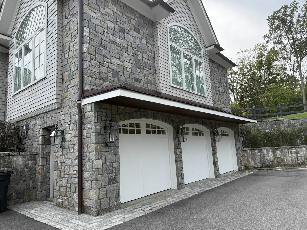 Copper gutter and downspout alignment at the garage