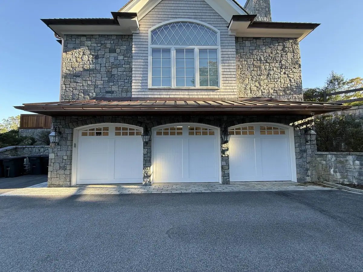 Completed copper gutter installation across the garage front