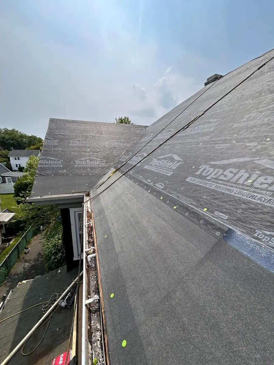 Roof edge and waterproofing detail prepared for new shingle installation