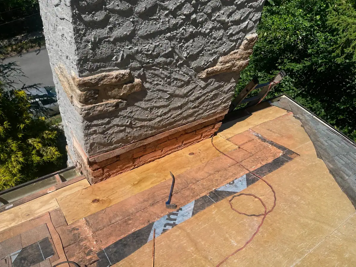 New wood decking installed at the chimney-side roof transition