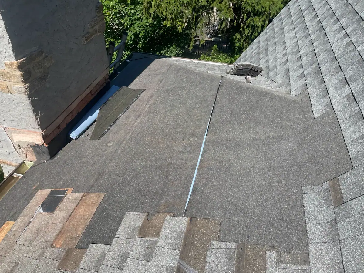 Ice and water protection being installed around the chimney roof area